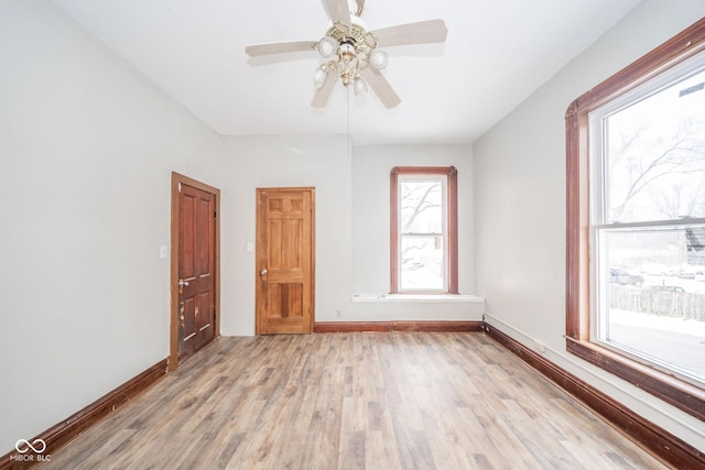 unfurnished room with ceiling fan and light wood-type flooring