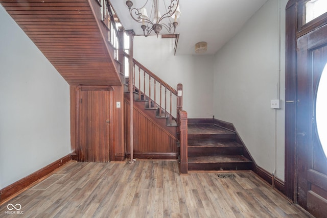 stairway featuring a chandelier and hardwood / wood-style floors