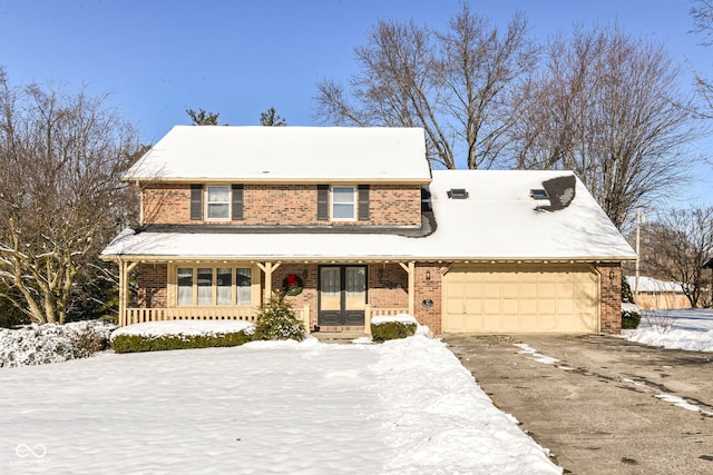 view of front of property with covered porch and a garage