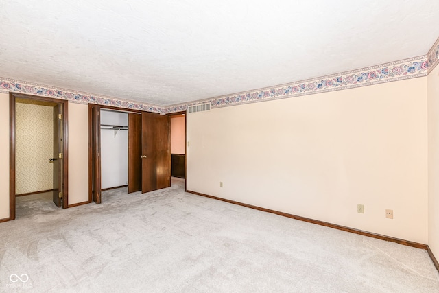 unfurnished bedroom with light colored carpet