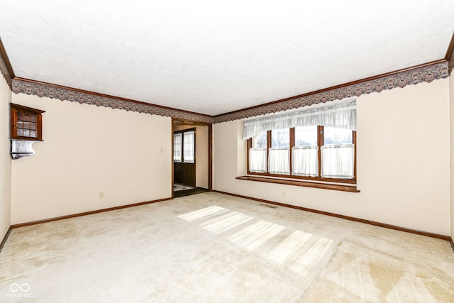 carpeted empty room featuring ornamental molding