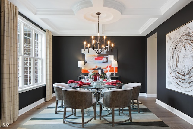 dining area featuring hardwood / wood-style flooring, a chandelier, ornamental molding, and coffered ceiling