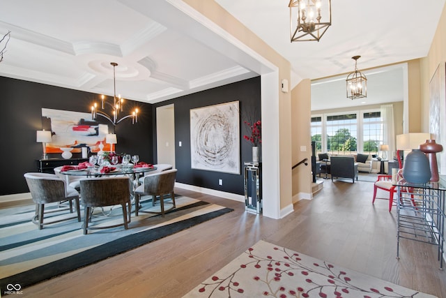 dining space featuring hardwood / wood-style floors, coffered ceiling, crown molding, a notable chandelier, and beam ceiling