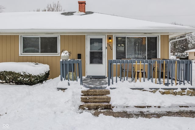 view of snow covered property entrance