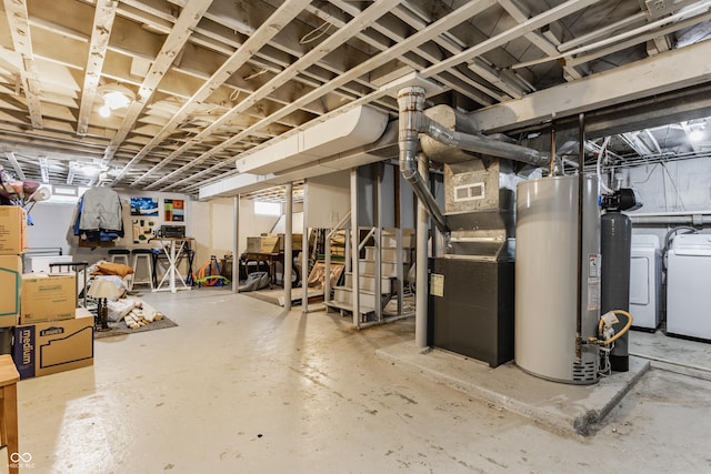 basement with washing machine and dryer, water heater, and heating unit