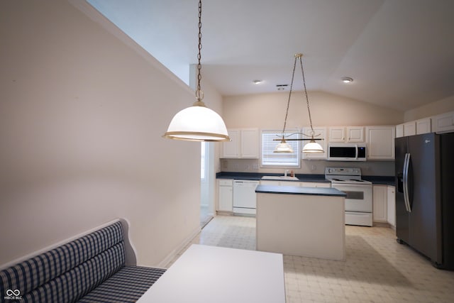 kitchen with white appliances, sink, decorative light fixtures, a center island, and white cabinetry