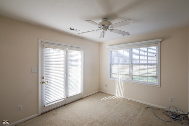 unfurnished room featuring light carpet and ceiling fan