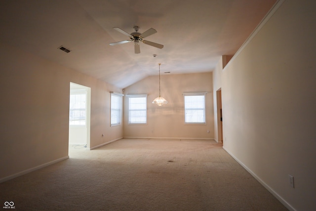 carpeted empty room featuring ceiling fan and vaulted ceiling