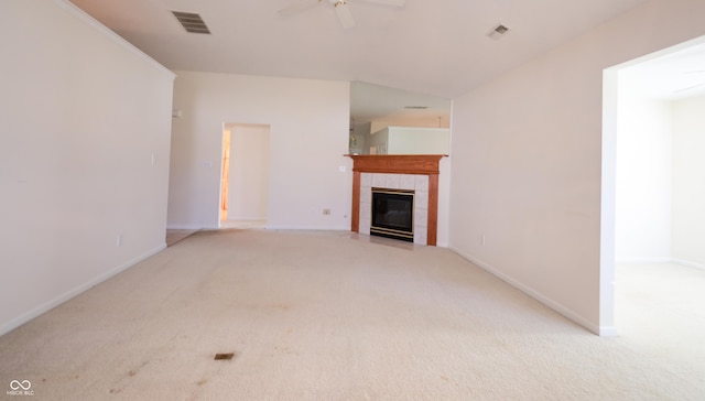 unfurnished living room featuring ceiling fan, a fireplace, and light colored carpet