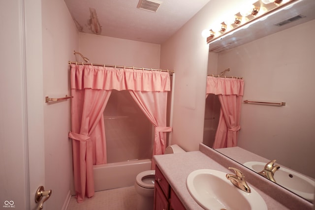 full bathroom featuring tile patterned flooring, a textured ceiling, toilet, shower / bath combo with shower curtain, and vanity