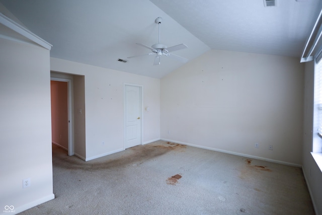 interior space featuring light colored carpet, ceiling fan, and lofted ceiling