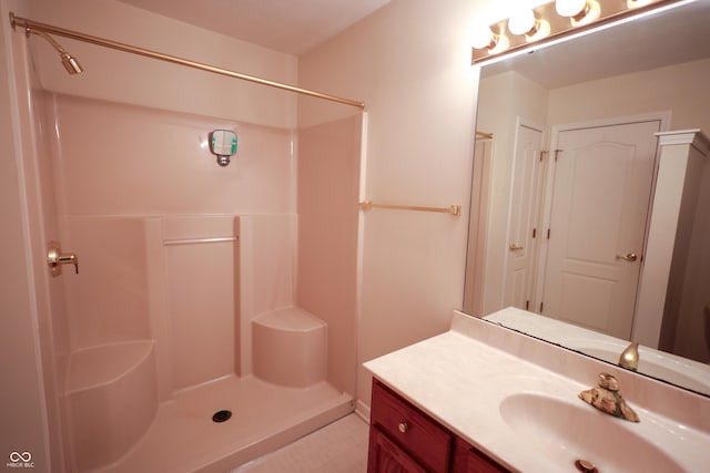 bathroom with a shower and vanity