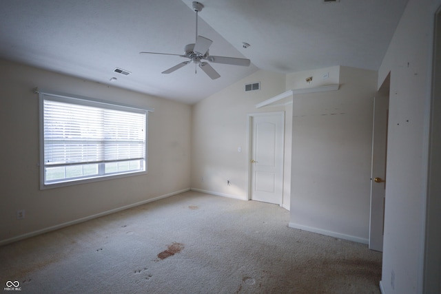 empty room with light colored carpet, ceiling fan, and lofted ceiling