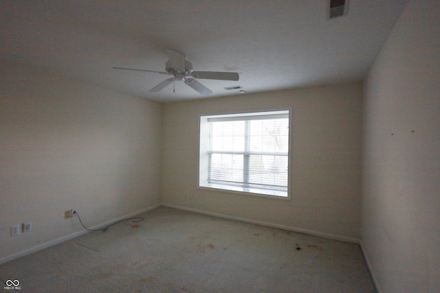 spare room with ceiling fan and light colored carpet