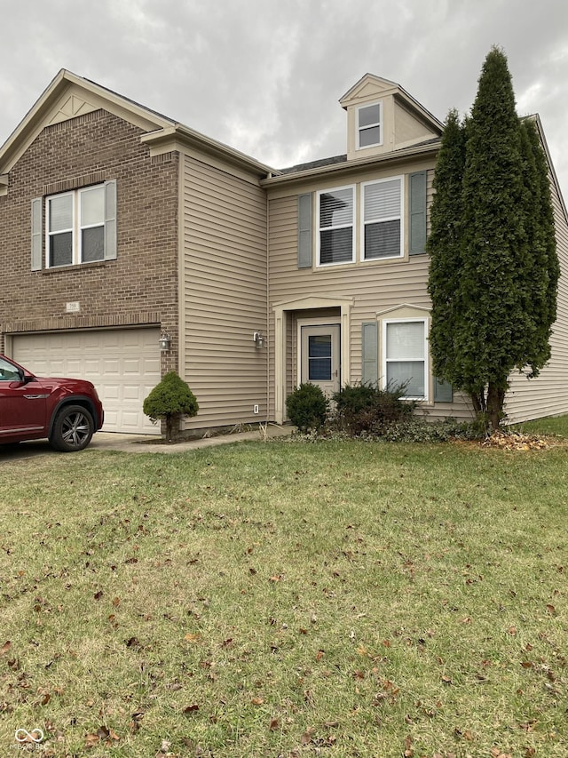 view of property with a front lawn and a garage