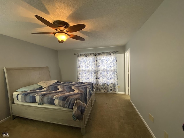 bedroom with ceiling fan, carpet floors, and a textured ceiling