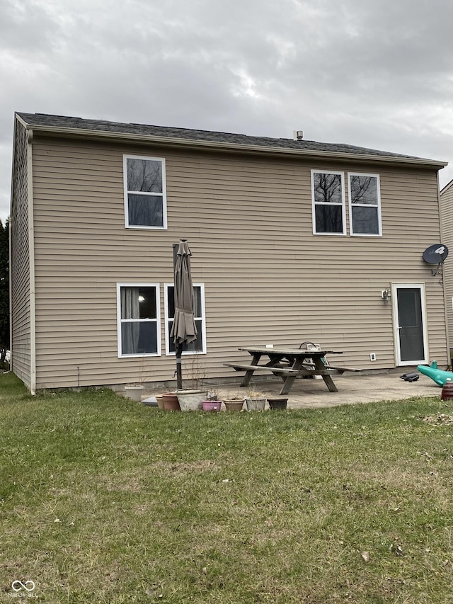 rear view of property featuring a patio area and a yard