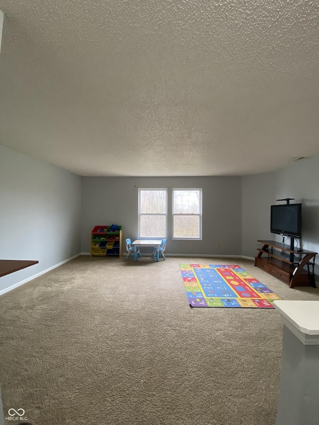 game room with carpet flooring and a textured ceiling