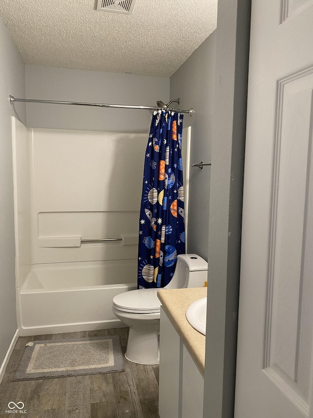 full bathroom featuring a textured ceiling, toilet, shower / bath combo with shower curtain, vanity, and hardwood / wood-style flooring