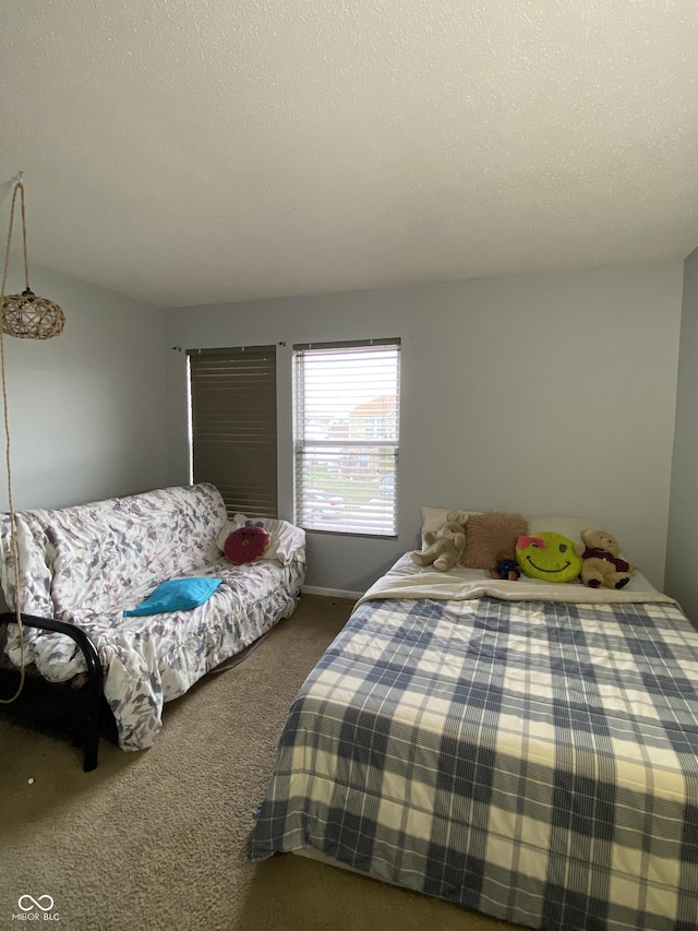 carpeted bedroom featuring a textured ceiling