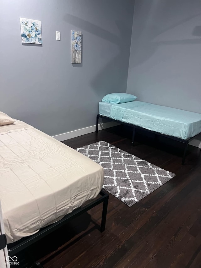 bedroom with pool table and hardwood / wood-style flooring