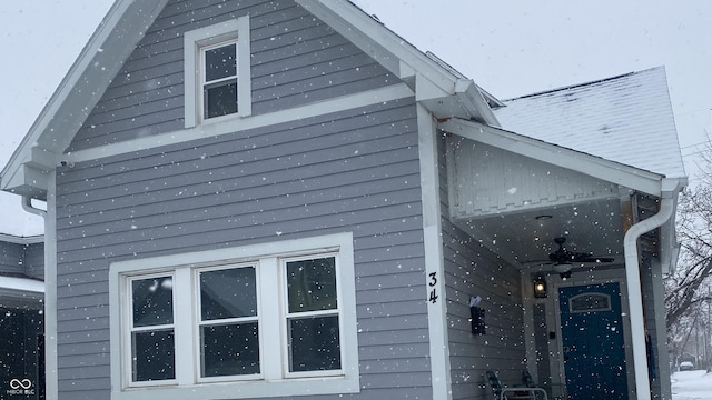 view of side of property with ceiling fan