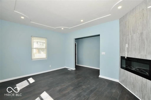 unfurnished living room with a fireplace and dark hardwood / wood-style floors