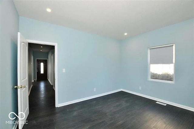 unfurnished room featuring dark wood-type flooring