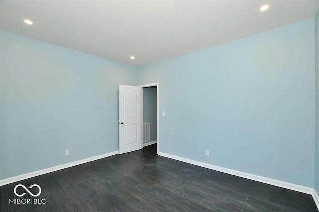 spare room with dark hardwood / wood-style flooring