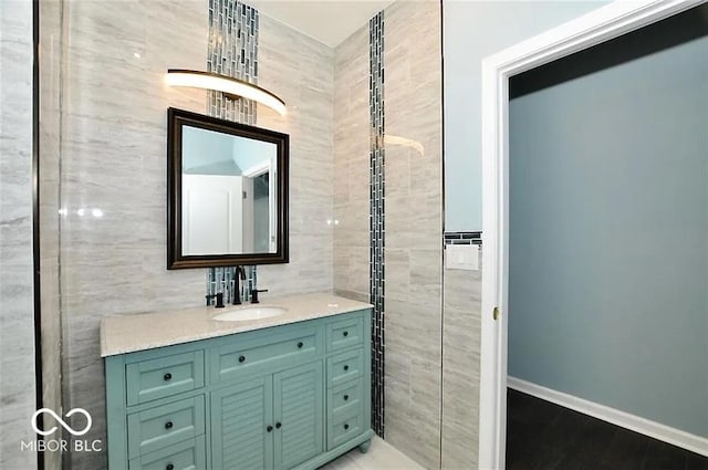 bathroom with vanity and tile walls