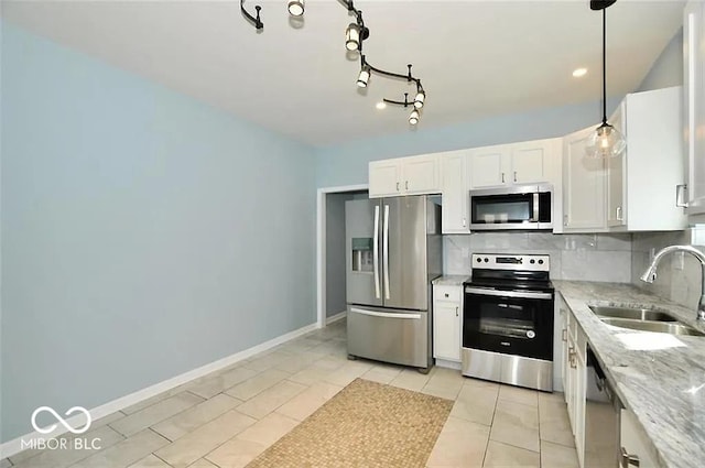 kitchen with stainless steel appliances, sink, pendant lighting, light tile patterned floors, and white cabinets