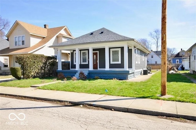 bungalow-style home with a front yard and a porch