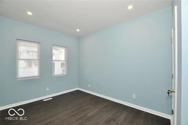 unfurnished room with dark hardwood / wood-style flooring