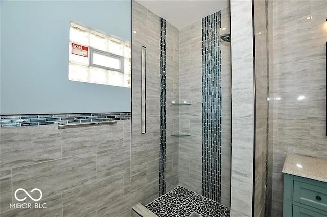 bathroom featuring tile walls and tiled shower