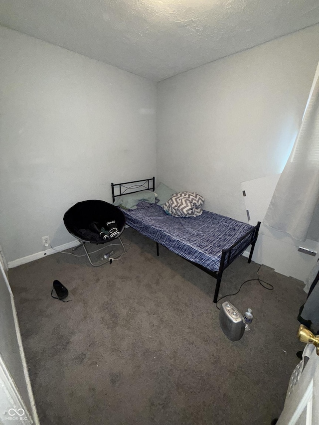 unfurnished bedroom with carpet and a textured ceiling