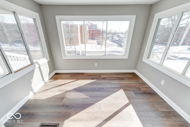 unfurnished sunroom with visible vents