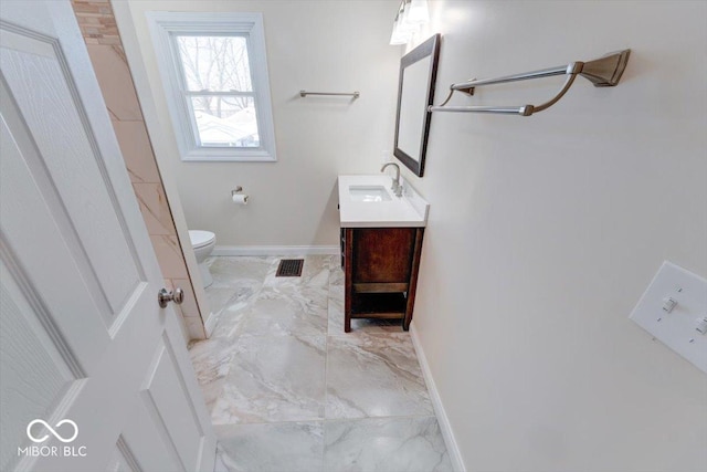 bathroom featuring toilet, vanity, visible vents, baseboards, and marble finish floor