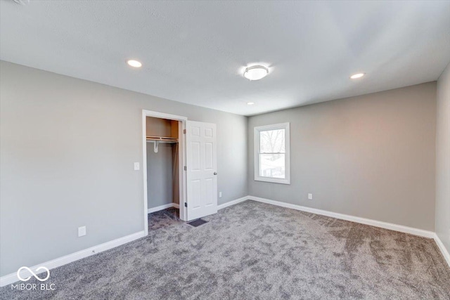 unfurnished bedroom with carpet floors, baseboards, a closet, and recessed lighting