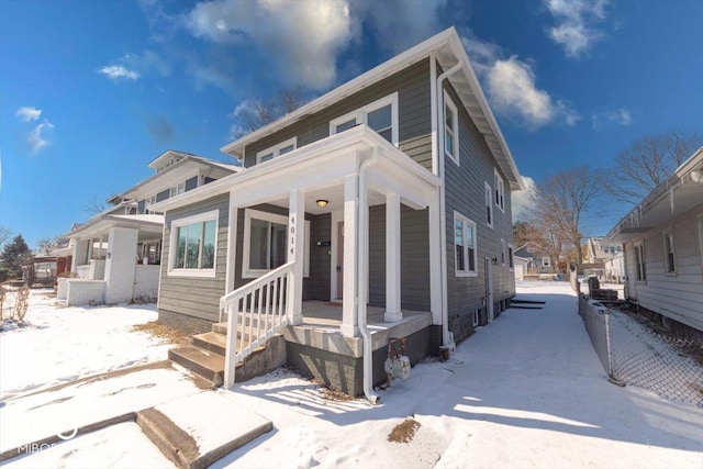 american foursquare style home featuring a porch