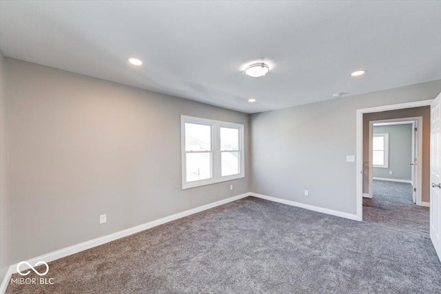 spare room featuring carpet, baseboards, and recessed lighting