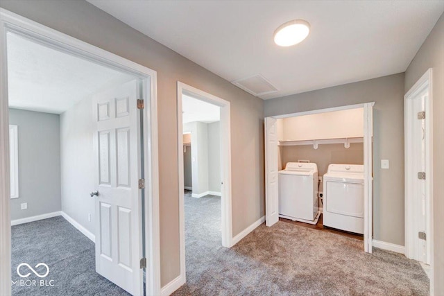 laundry area with laundry area, attic access, baseboards, carpet, and washing machine and dryer