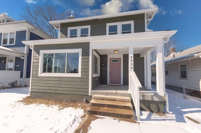 view of front of home with covered porch and fence