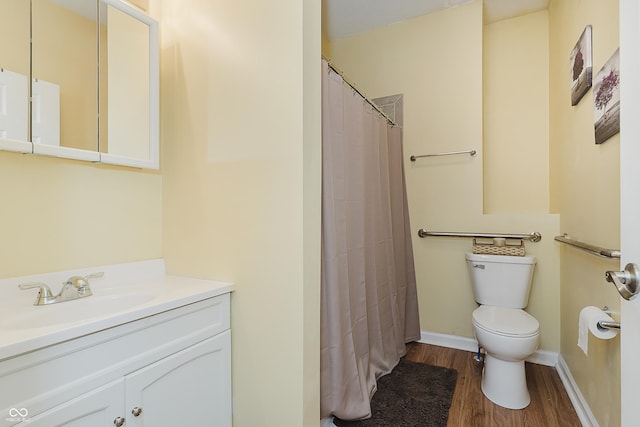 bathroom featuring a shower with curtain, vanity, hardwood / wood-style flooring, and toilet