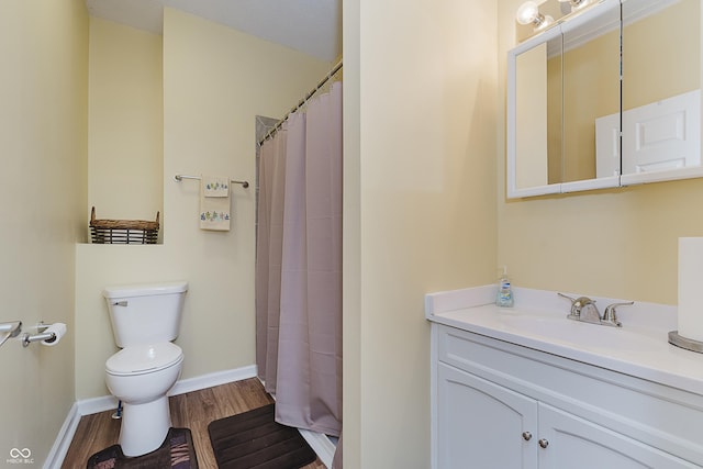 bathroom with walk in shower, vanity, wood-type flooring, and toilet