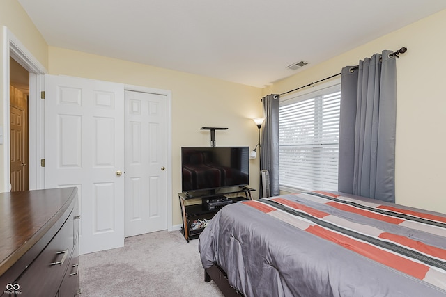 carpeted bedroom with a closet