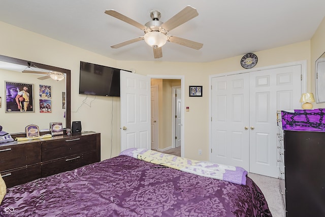 carpeted bedroom featuring ceiling fan and a closet