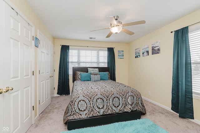 bedroom with ceiling fan and light carpet