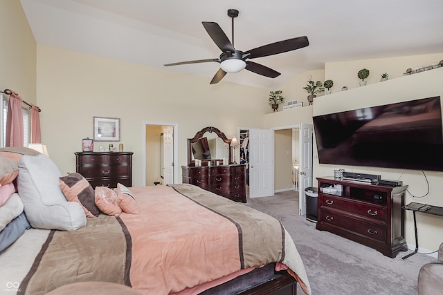 bedroom featuring light colored carpet, vaulted ceiling, ceiling fan, a spacious closet, and a closet