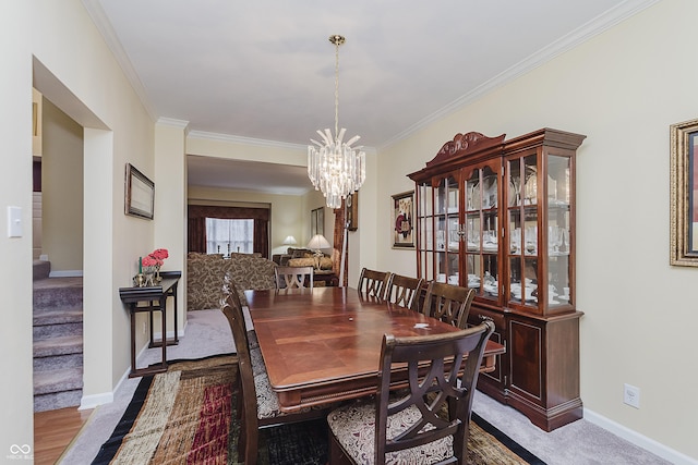 dining area with light colored carpet, crown molding, and a notable chandelier