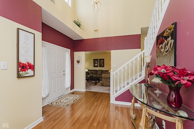 entryway featuring hardwood / wood-style flooring and a high ceiling